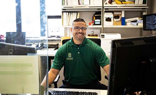 Campus safety officer sitting at his desk